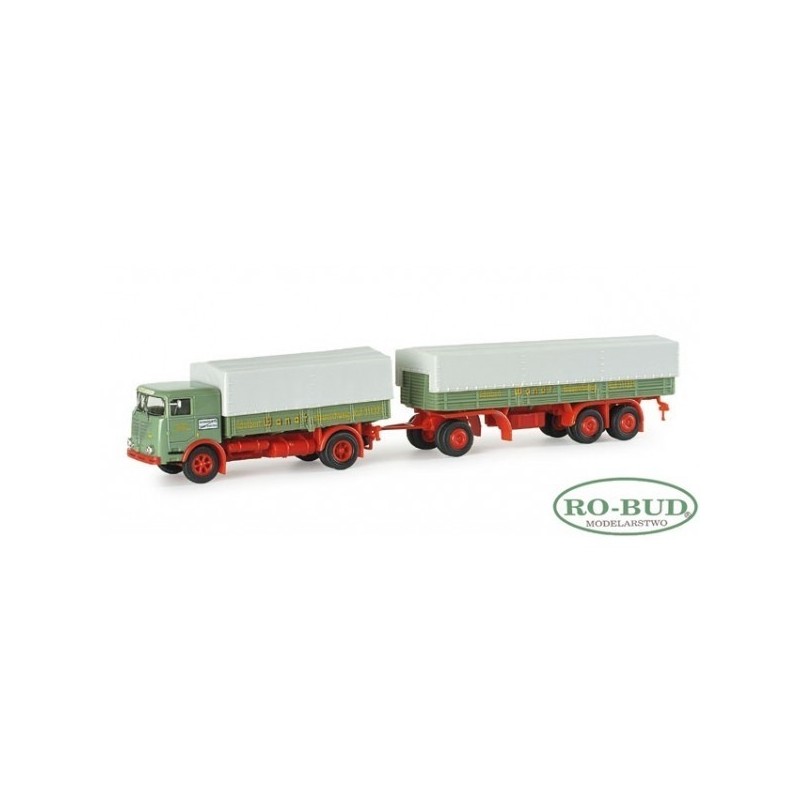 Model redukcyjny Buessing LU 11 "Wandt", skala 1:87, HERPA. Zielony ciągnik siodłowy z czerwonymi detalami i białymi naczepami.