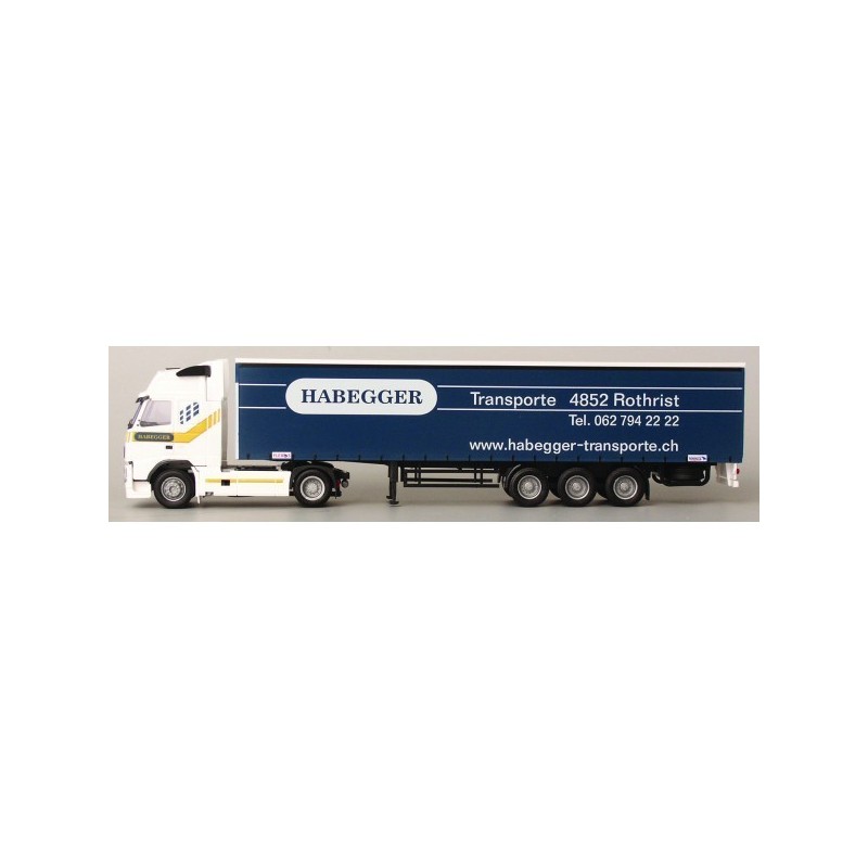 Model redukcyjny Volvo FH, skala 1:87, AWM. Biała kabina, niebieska naczepa z logotypem Habegger.