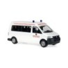 Model redukcyjny VW T5 Transporter Bus, skala 1:87, biały z czerwonymi napisami i niebieskimi światłami.
