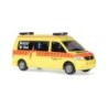 Model redukcyjny Volkswagen T5 KSW Ambulanz Winterthur, skala 1:87, żółty z pomarańczowymi pasami.
