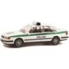 Model redukcyjny Audi 100, skala 1:87, Rietze. Biały z zielonymi pasami, napis Policie.