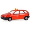 Model redukcyjny FIAT Tipo Met, skala 1:87. Czerwony samochód z białymi oznaczeniami.