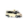 Model redukcyjny Ford Transit 2006 Taxi, skala 1:87. Jasnożółty taksówka z czarnymi akcentami i żółtymi sygnałami.